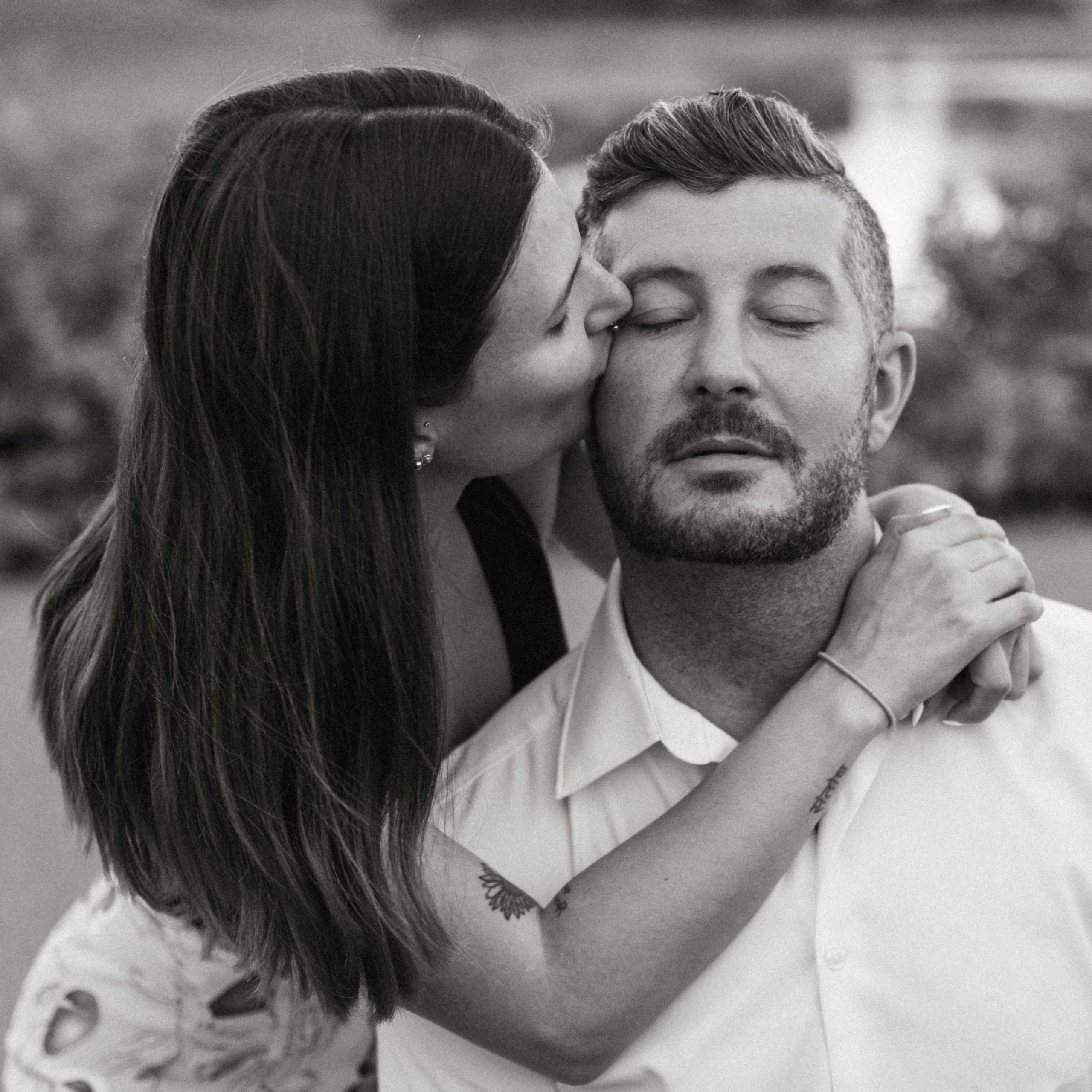 A woman kissing her lover's cheek.